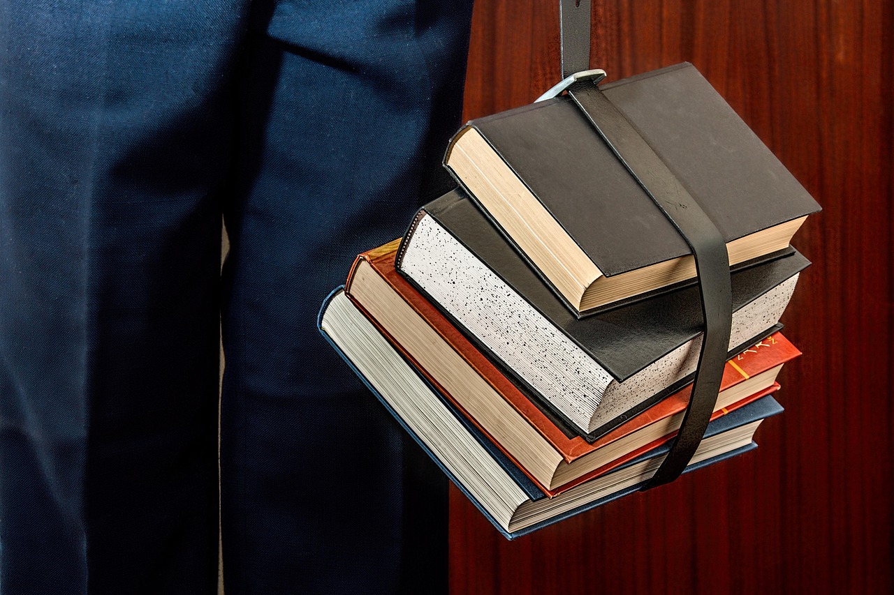 Student studying with books in a university library