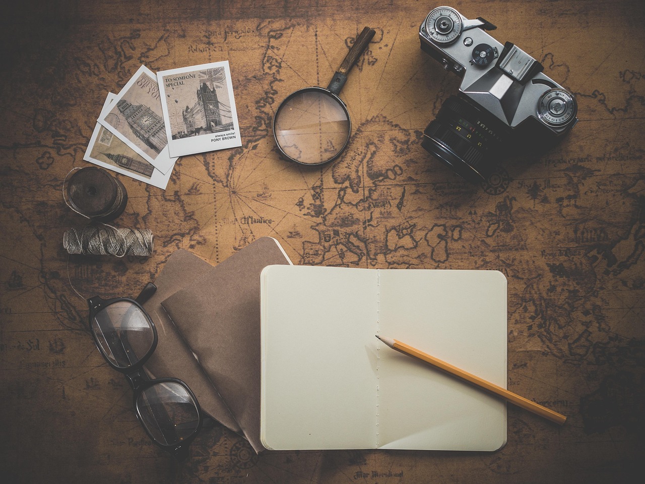 Travel map, notes and glasses for planning an affordable multi-country trip